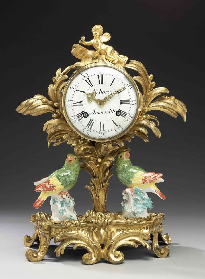 A gilt-bronze pendulum clock with two Meissen parrots